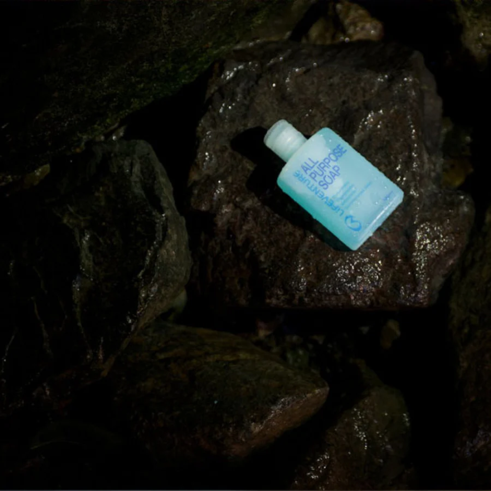 Lifeventure All Purpose Soap - 100ml sitting on the rocks