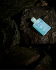 Lifeventure All Purpose Soap - 100ml sitting on the rocks