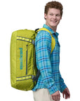 Patagonia Black Hole Duffel 55L (Matte Phosphorus Green) - Side On Person