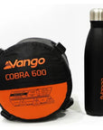 Vango Cobra 600 Down Filled Sleeping Bag (Anthracite) next to bottle