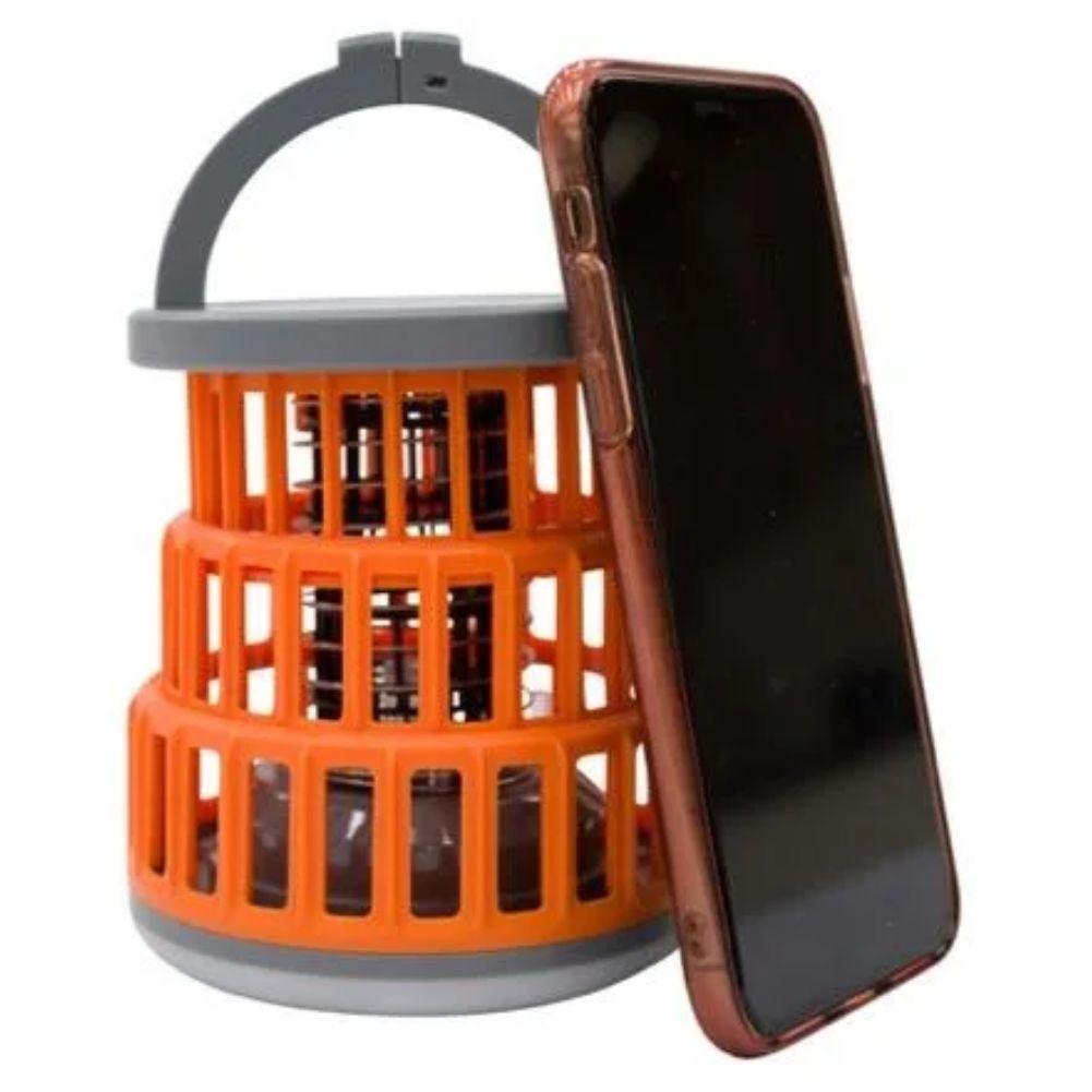 Vango Midge 100 Camping Lantern next to phone