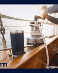 Yeti Rambler 20 OZ Tumbler (Navy) on the sea