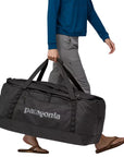 Patagonia Black Hole Duffel Bag 100L (Black) woman carrying bag