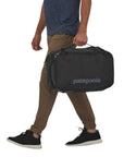 Patagonia Black Hole Mini MLC 30L (Black) walking with bag