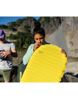 Thermarest NeoAir XLite NXT Sleeping Mat - Regular (Lemon Curry) women blowing