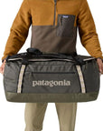 Patagonia Black Hole Duffel Bag 70L (Pine Needle Green) side holding