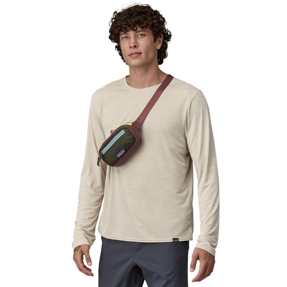 Patagonia Ultralight Black Hole Mini Hip Pack 1L (Patchwork: Pine Needle Green) over the shulders