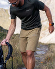 Montane Men's Tenacity Hiking Shorts (Olive) picking up bag