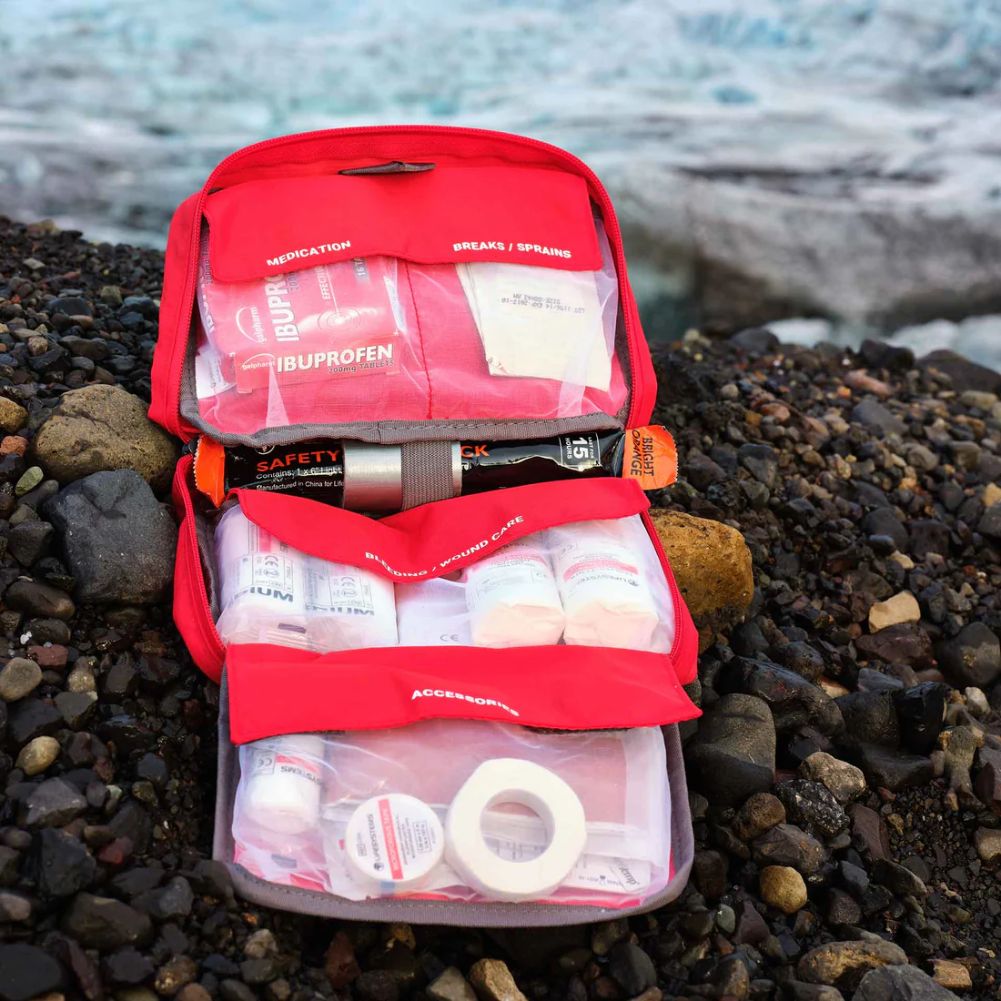 Lifesystems Mountain First Aid Kit open on the rocks