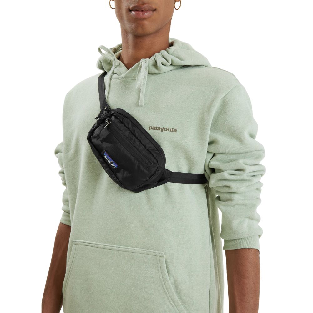 Patagonia Ultralight Black Hole Mini Hip Pack 1L (Black) model angle over shoulder