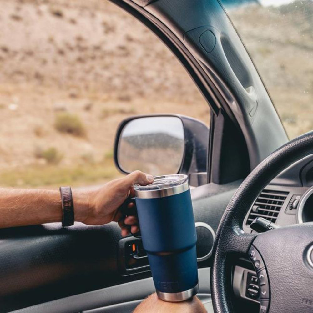 YETI Rambler 20 Oz Travel Mug (Navy) holding