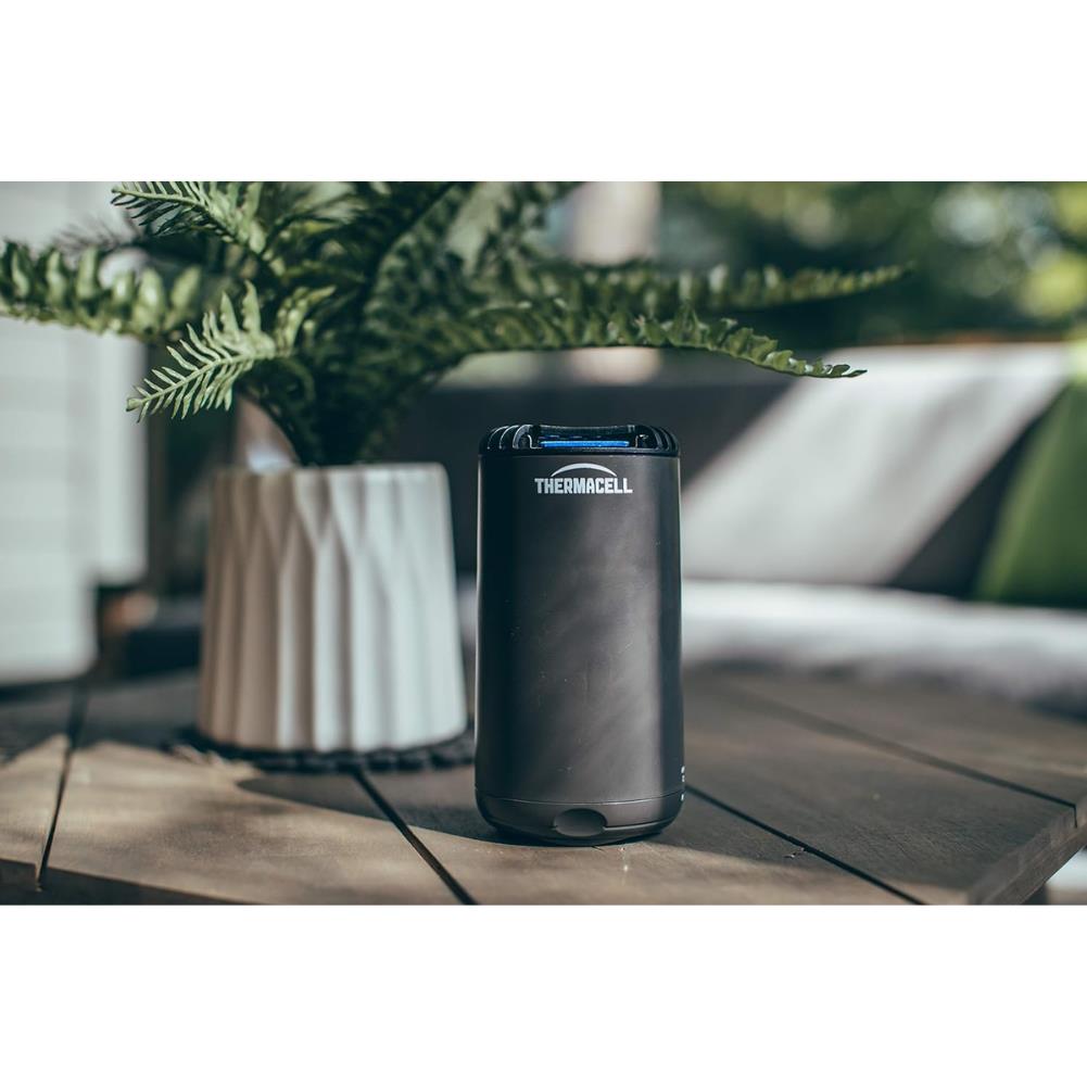 Thermacell Halo Mini Mosquito &amp; Midge Repeller (Graphite) next to plant
