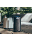 Thermacell Halo Mini Mosquito & Midge Repeller (Graphite) next to plant