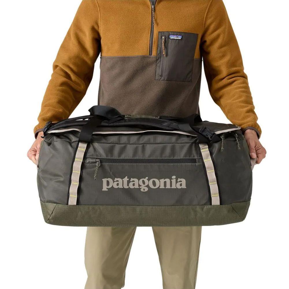 Patagonia Black Hole Duffel Bag 70L (Pine Needle Green) side holding