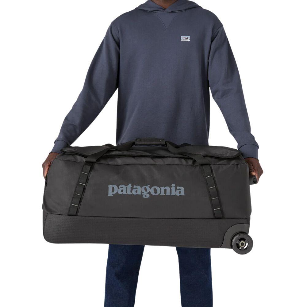 Patagonia Black Hole Wheeled Duffel Bag 100L (Black) holding sides