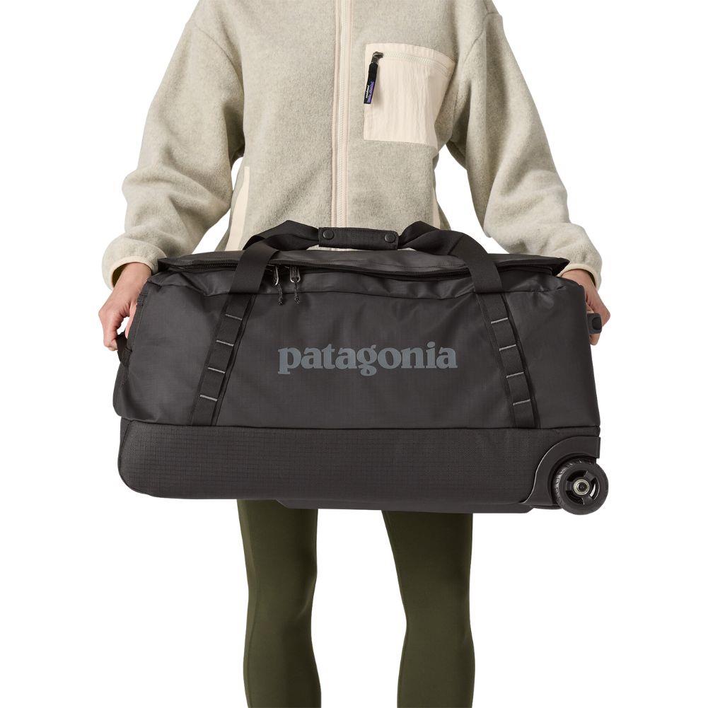 Patagonia Black Hole Wheeled Duffel 70L (Black) holding both side