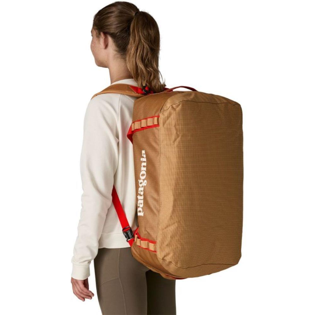 Patagonia Black Hole 55L Duffel Bag (Talon Gold) carrying on back